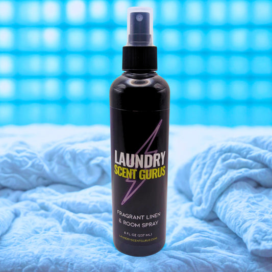 Bottle of Laundry Scent Gurus spray on a blue textured background
