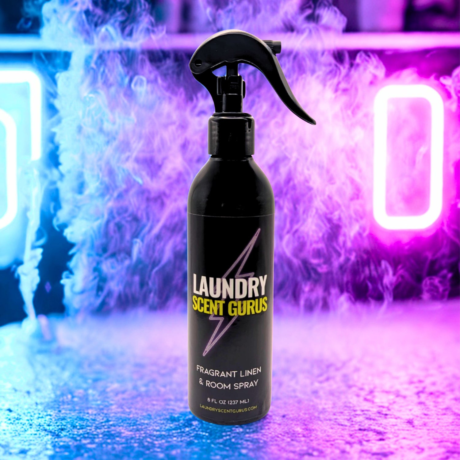 Black spray bottle labeled 'Laundry Scent Gurus' against a colorful, neon-lit background.