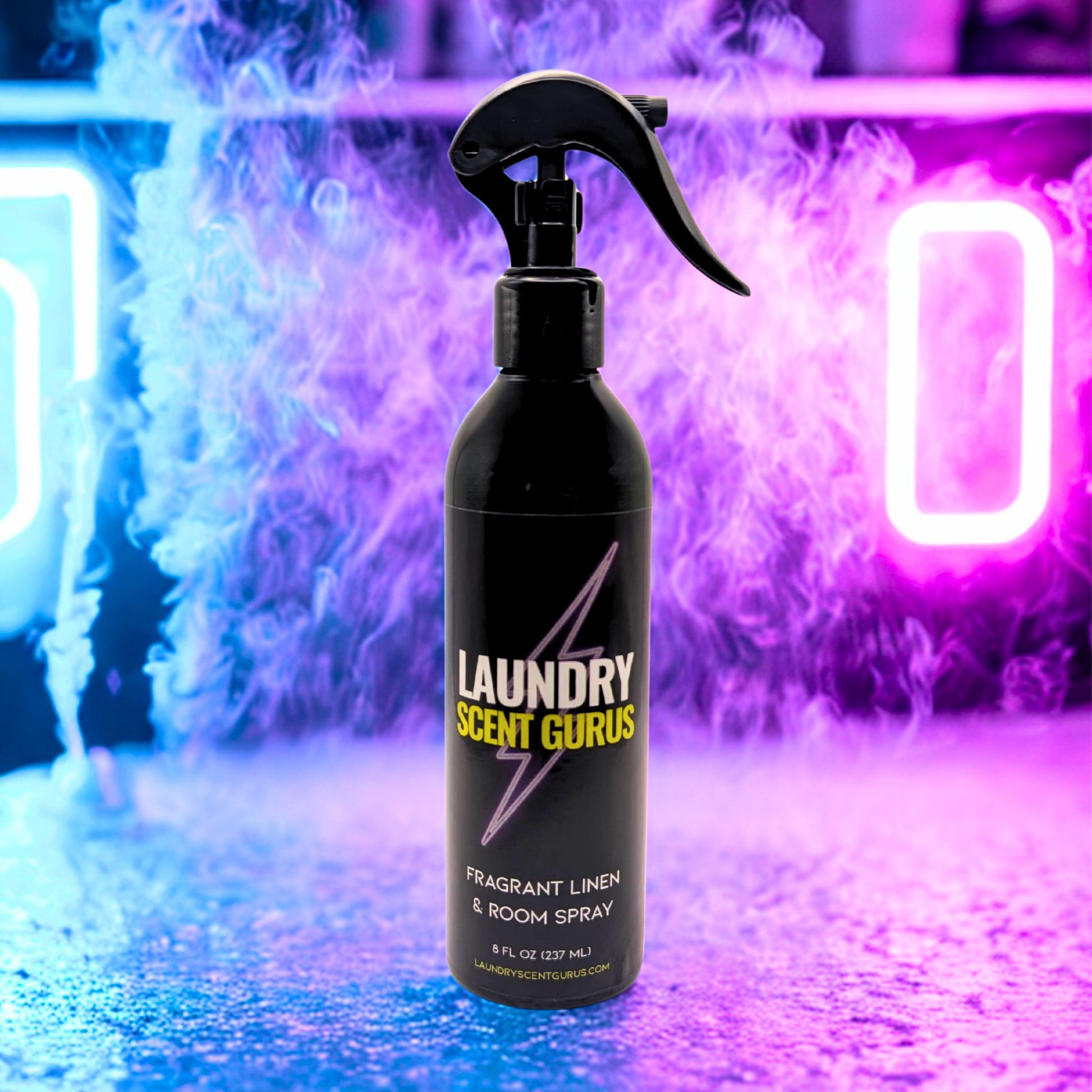 Black spray bottle labeled 'Laundry Scent Gurus' against a colorful, neon-lit background.