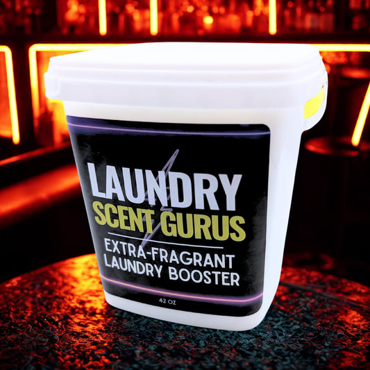 Laundry Scent Gurus extra-fragrant laundry booster container on a dark surface with neon lights in the background