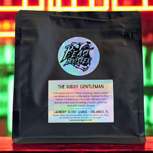 Black bag with a label featuring 'The Sudsy Gentleman' and branding on a colorful background