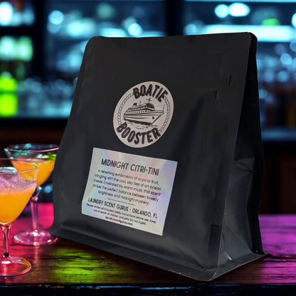 Black bag with a label on a bar counter with cocktails in the background