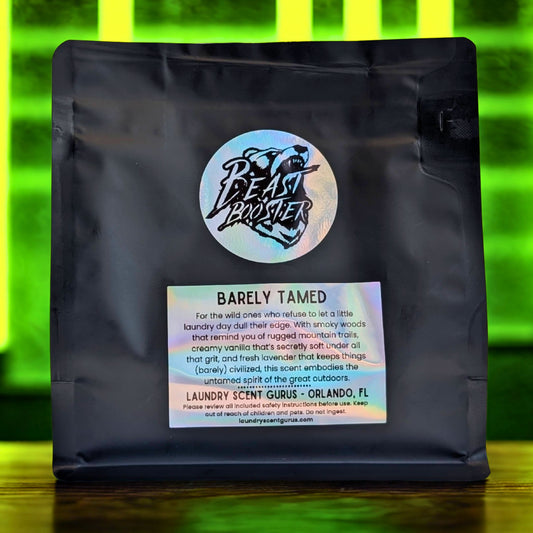 Black bag with a label featuring 'Barely Tamed' and branding on a green and yellow gradient background.