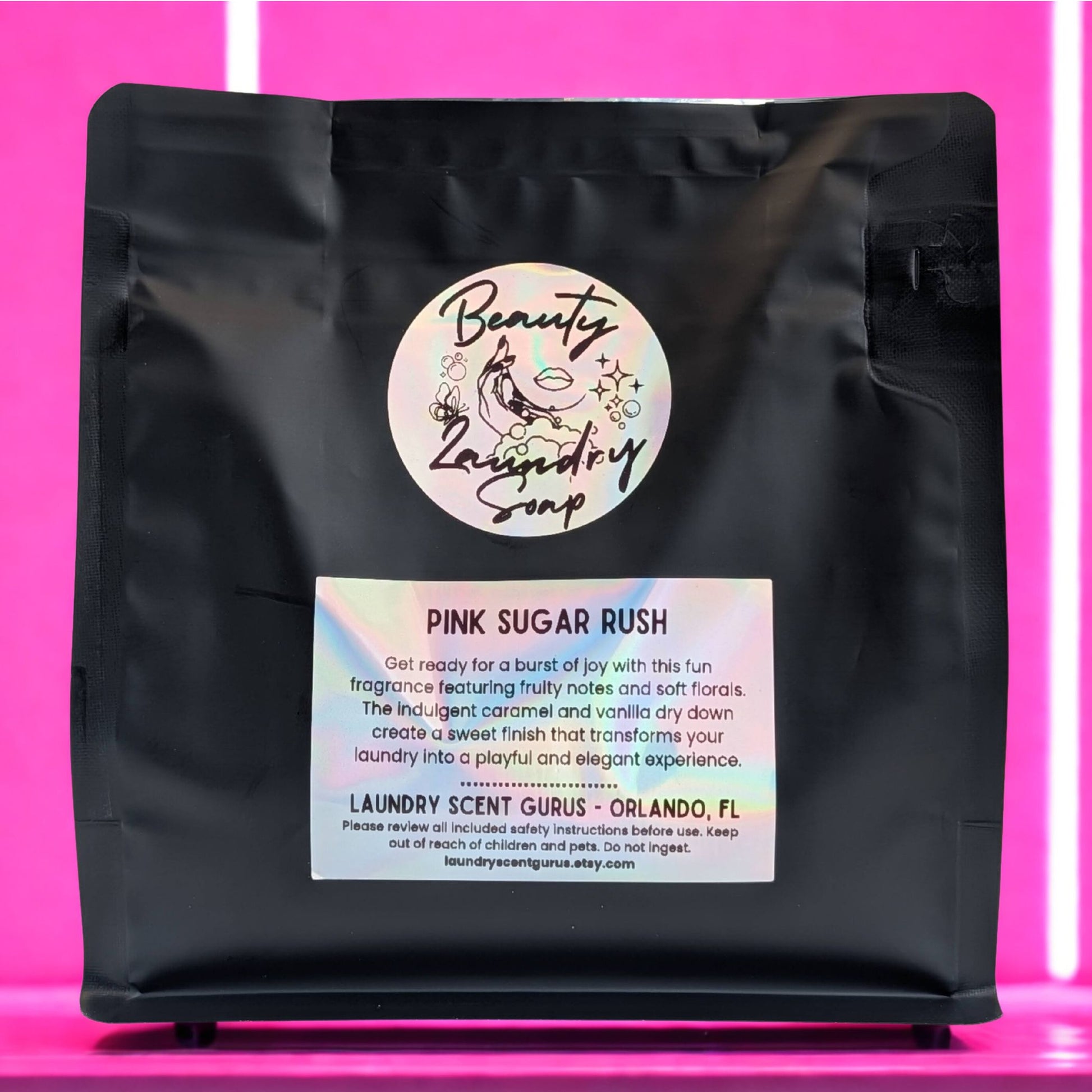 Black bag with 'Beauty & Laundry Soap' label on a pink background