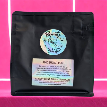 Black bag with 'Beauty Booster' label on a pink background