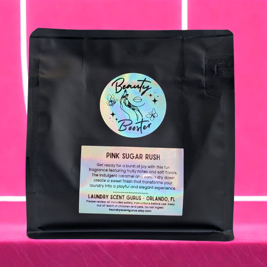 Black bag with 'Beauty Booster' label on a pink background