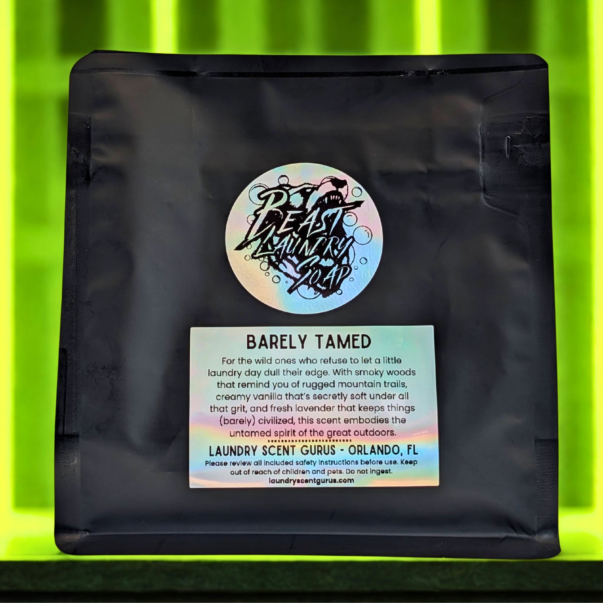 Black laundry bag with colorful label on a green background