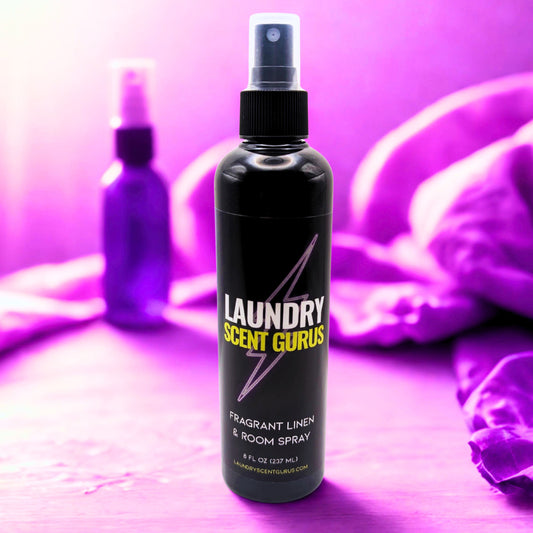 Black spray bottle labeled 'Laundry Scent Gurus' on a purple background