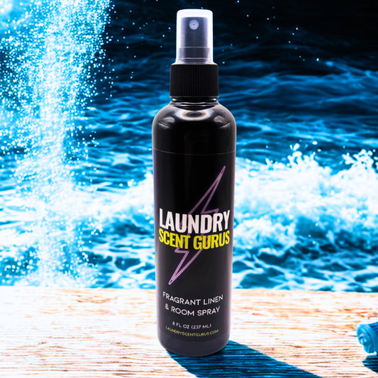 Laundry Scent Gurus spray bottle with water splashing in the background